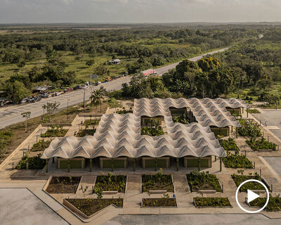 wavy brick roof spreads over open crafts market by aidia studio in mexico