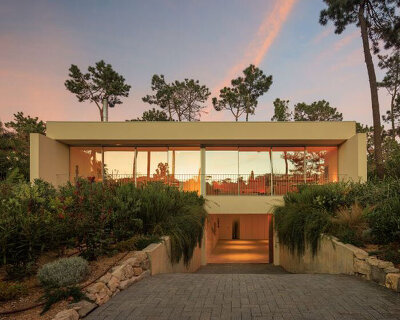 four planes coated in white stucco compose casa calma by araja studio in portugal