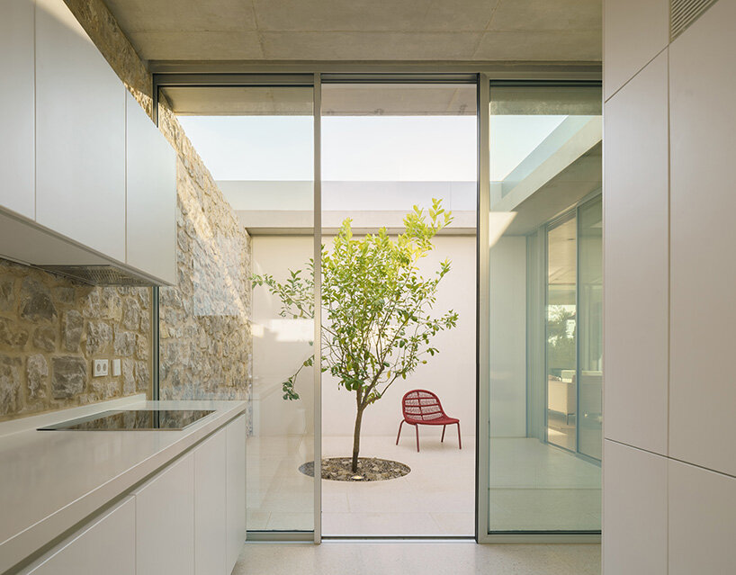 a material palette of stone, steel, and glass