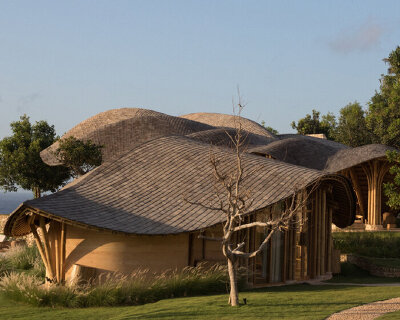 undulating roof echoing a moving fish tail tops pablo luna studio’s tea room in indonesia