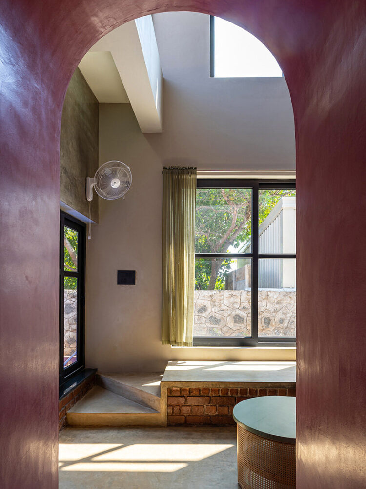 a curved archway connects to a bedroom