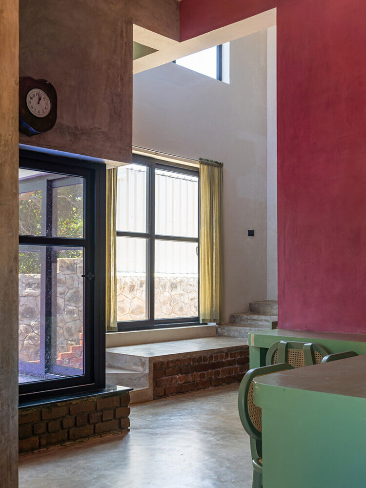 a stepped living and dining area lead into a compact kitchen