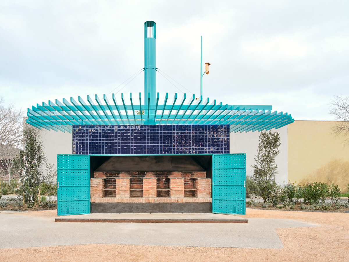 ceramic blue tiles evoking mediterranean hues clad h3o architects' public barbecue in spain