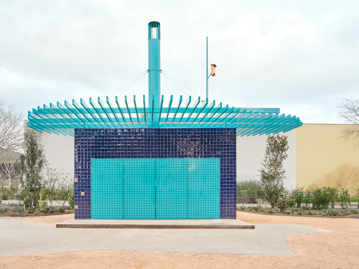 ceramic blue tiles evoking mediterranean hues clad h3o architects' public barbecue in spain