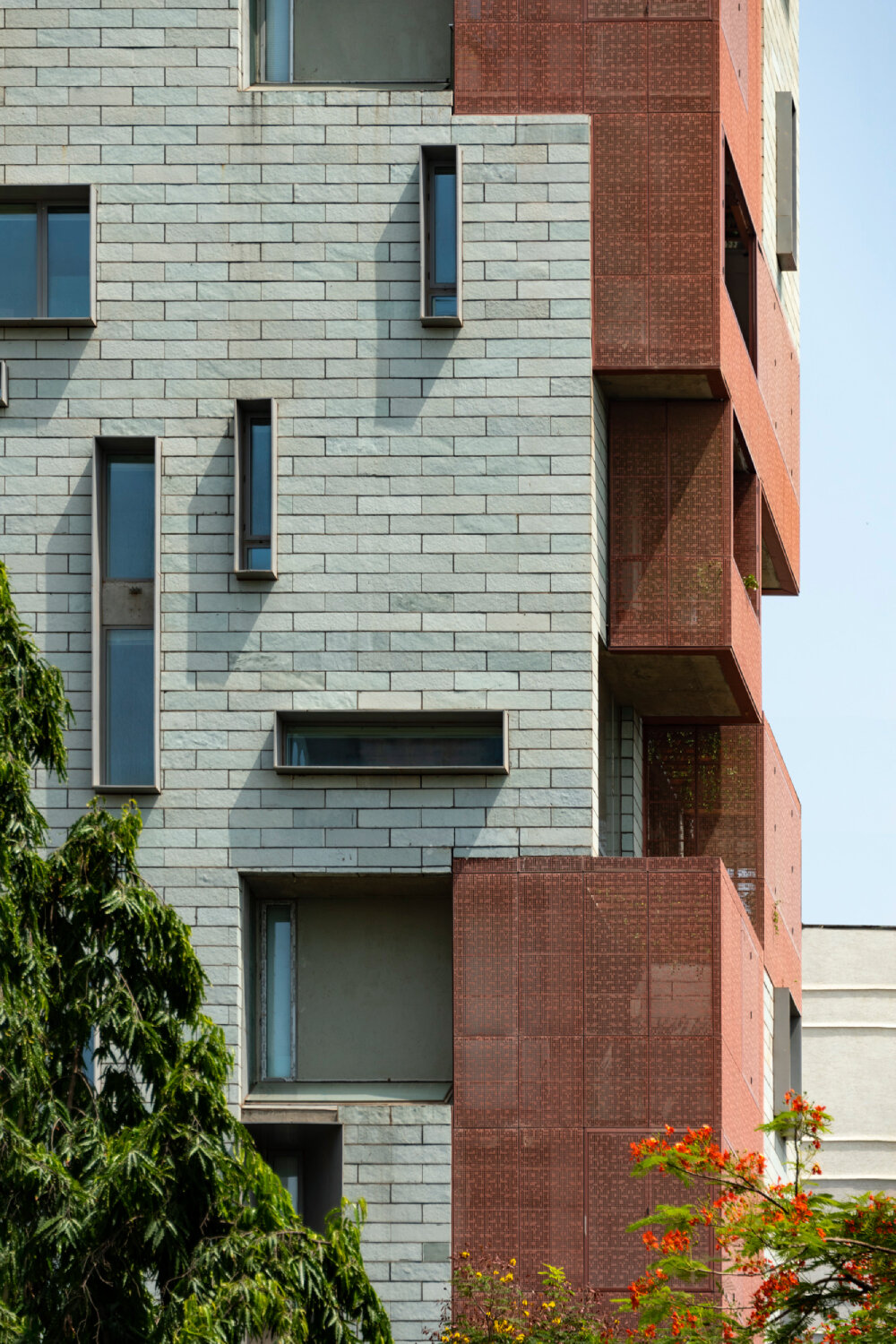 verandahs wrapped in adjustable perforated screens shape malik architecture's residential tower in mumbai