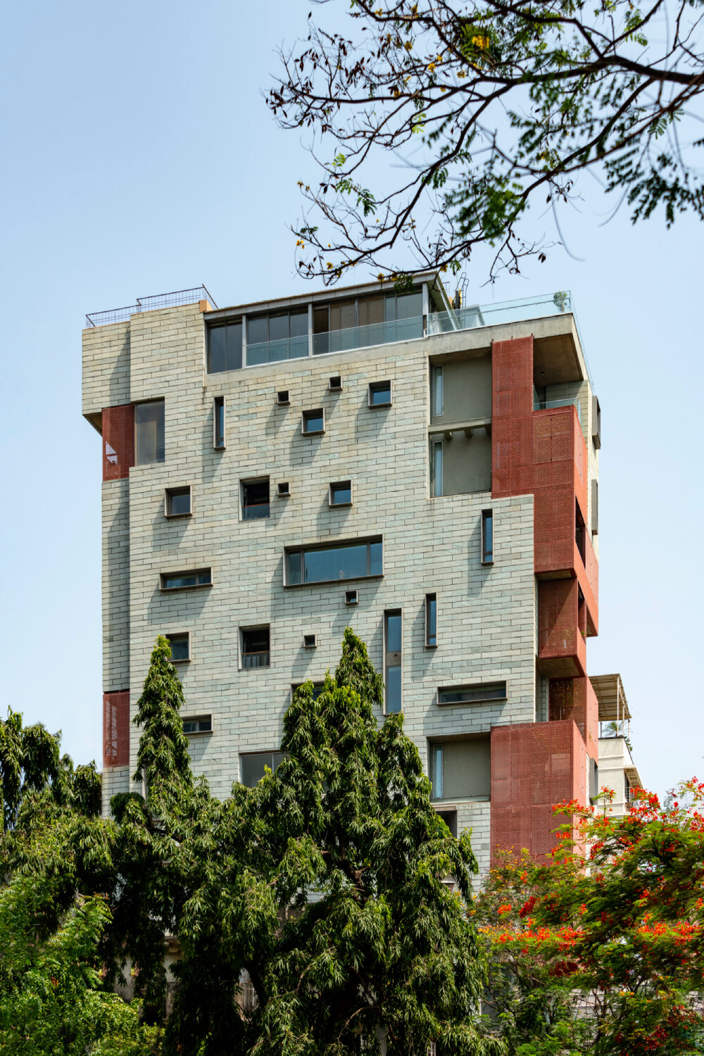 verandahs wrapped in adjustable perforated screens shape malik architecture's residential tower in mumbai