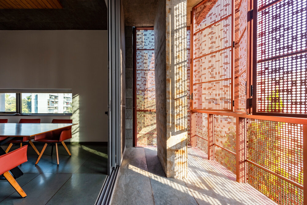 verandahs wrapped in adjustable perforated screens shape malik architecture's residential tower in mumbai