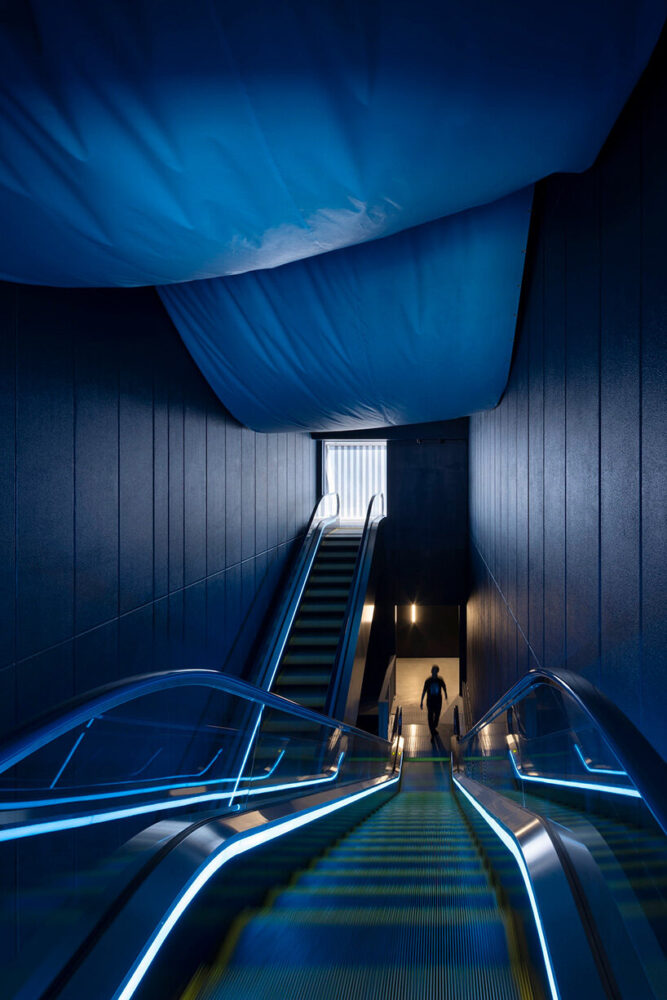 the ceiling above the escalator space is finished with blue tarp