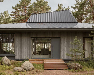 tilted roof sculpts geometric skylight atop UZV family residence by open AD in latvia