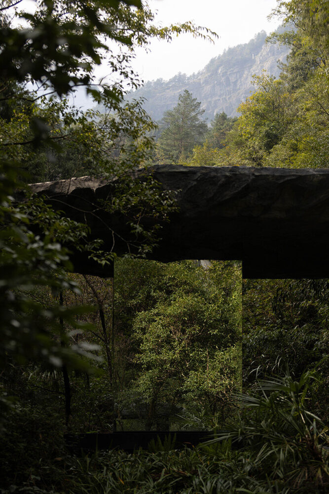 a massive six-meter-long boulder seems to float above the structure