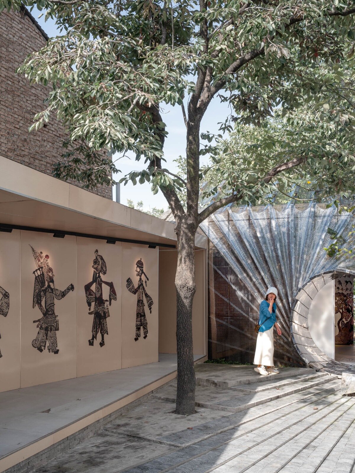 steel mesh curtain veiling daipu architects' china culture hall doubles as rain collecting device