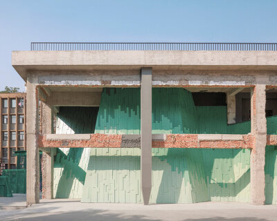 wutopia lab's layered green facade recalling chinese painting transforms factory into theater
