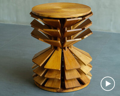 salù iwadi studio layers spiraling wooden fins to form zangbeto side table