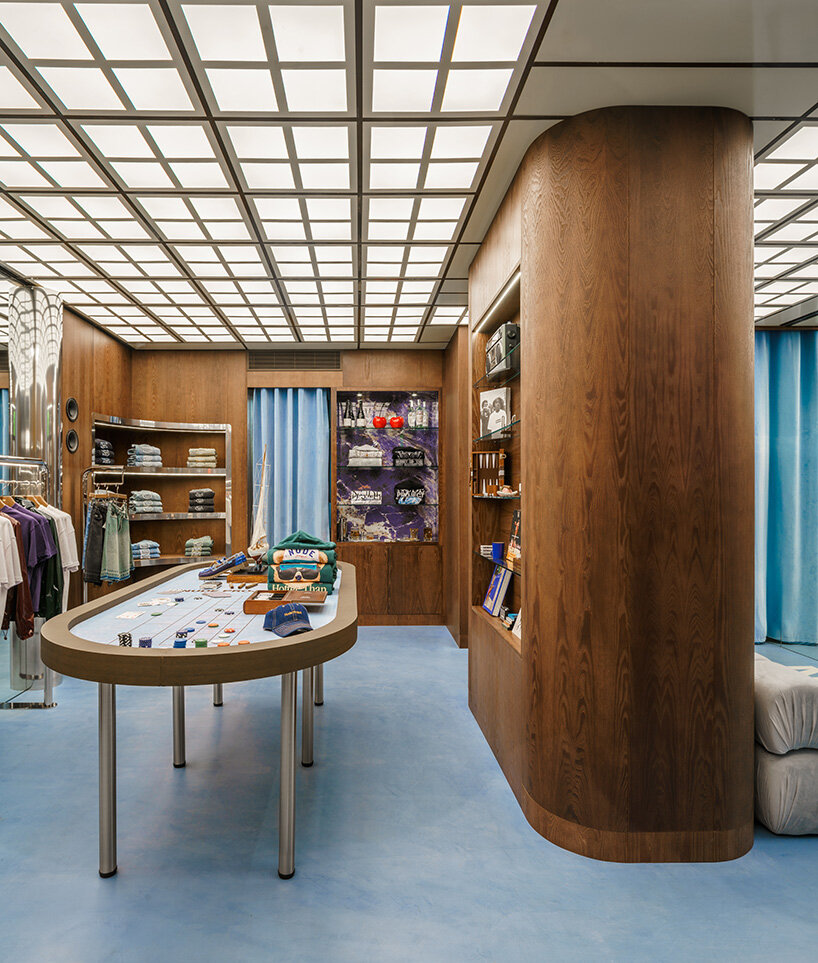 the poker table is surrounded by softly curved wood shelving