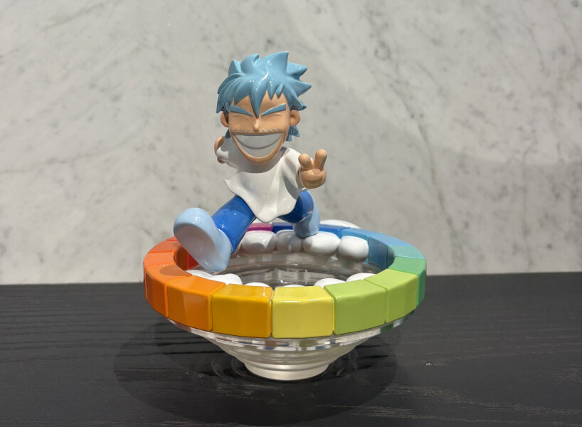 Dino on top of a colorful funnel wheel | image © designboom