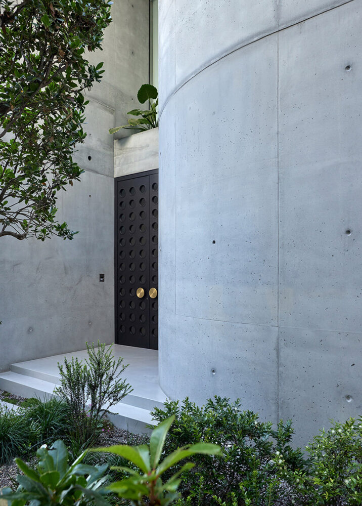 a bespoke bronze and brass door punctuated by circular motifs