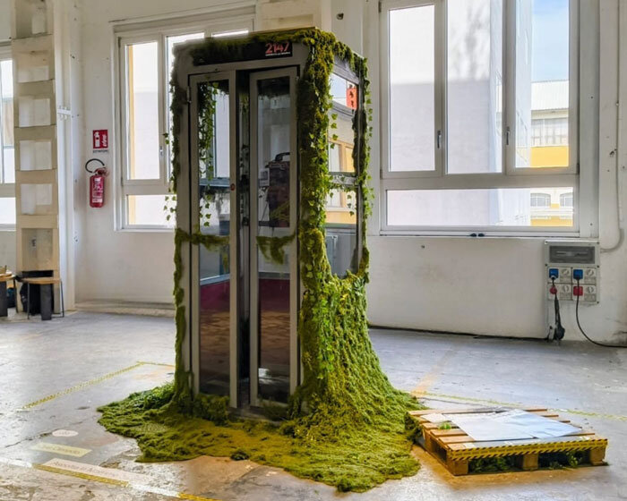 AI voice agent embeds within moss-covered phone booth at milan design week