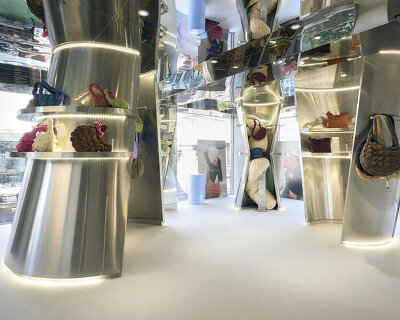 mirroring steel coats carlyn showroom's fluid curved interiors in seoul