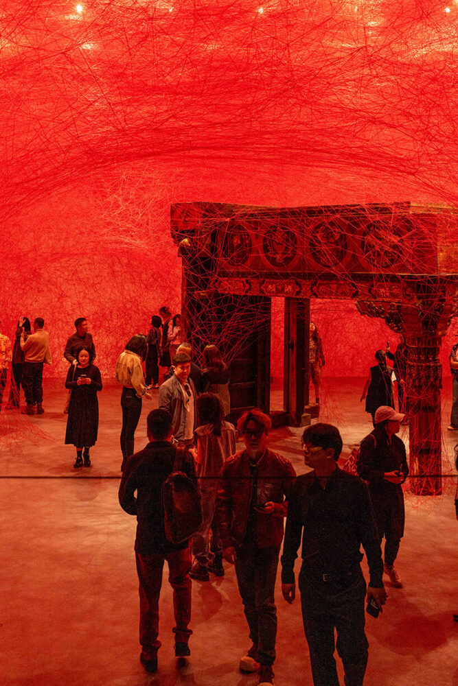 red threads slice through walls and spill into the gallery | image courtesy of Red Brick Art Museum