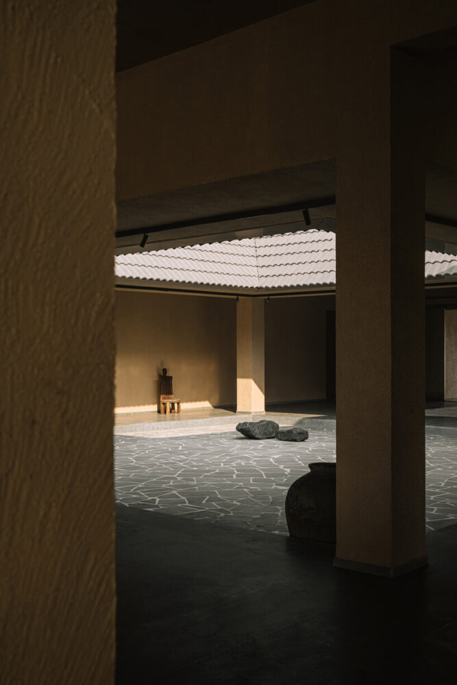 an interplay of light and shadow in a courtyard that blurs boundaries between interior and exterior