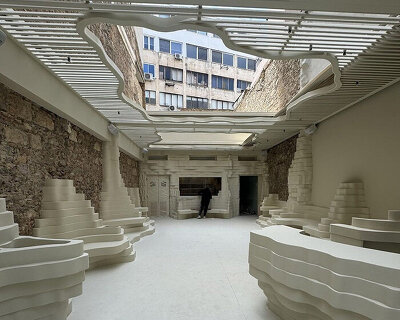 snarkitecture's burger bar takes form in athens with creamy, canyon-like interiors
