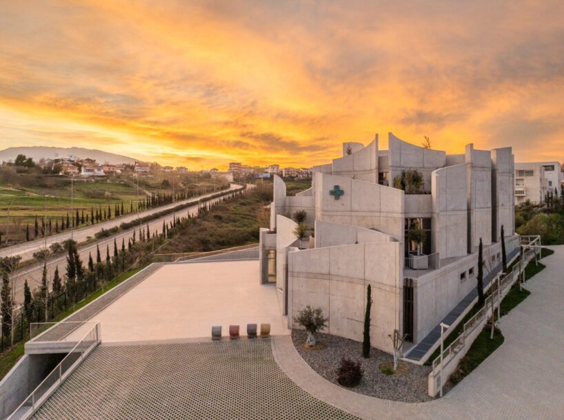 davide macullo's veterinary clinic hides behind a cluster of concrete curves in albania