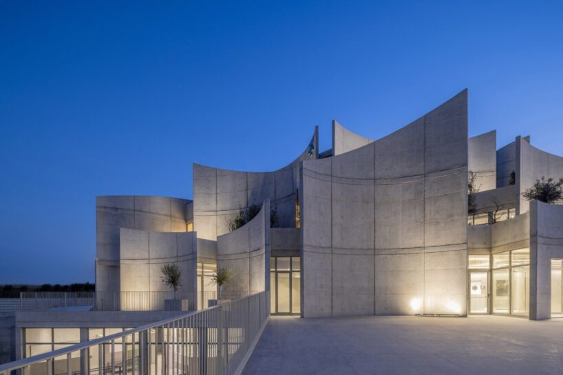 davide macullo's veterinary clinic hides behind a cluster of concrete curves in albania