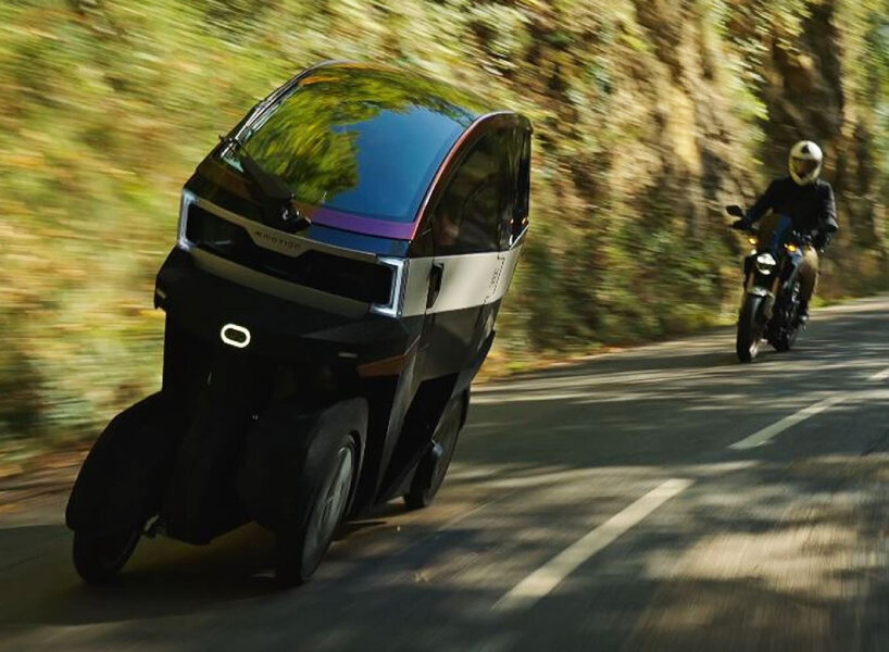 the four-wheeler next to a standard motorcycle