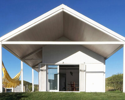 open structural steel grid by estudio BNAA reinterprets barn typology in argentina