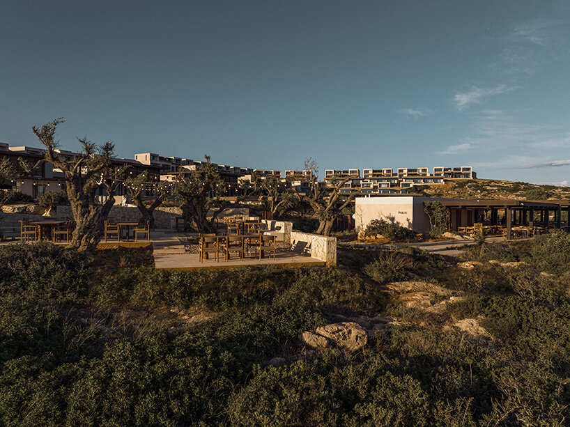 creating a sense that the buildings are part of the earth itself