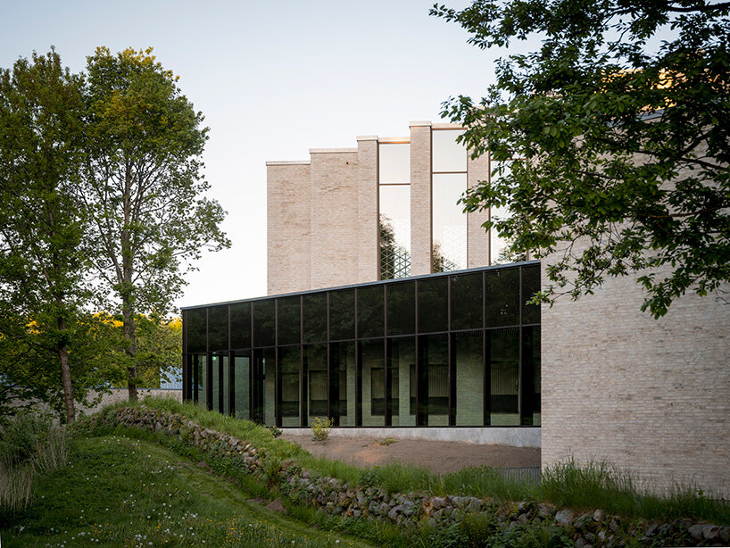 the use of perforated brick walls and brass details allow natural light to filter in gently