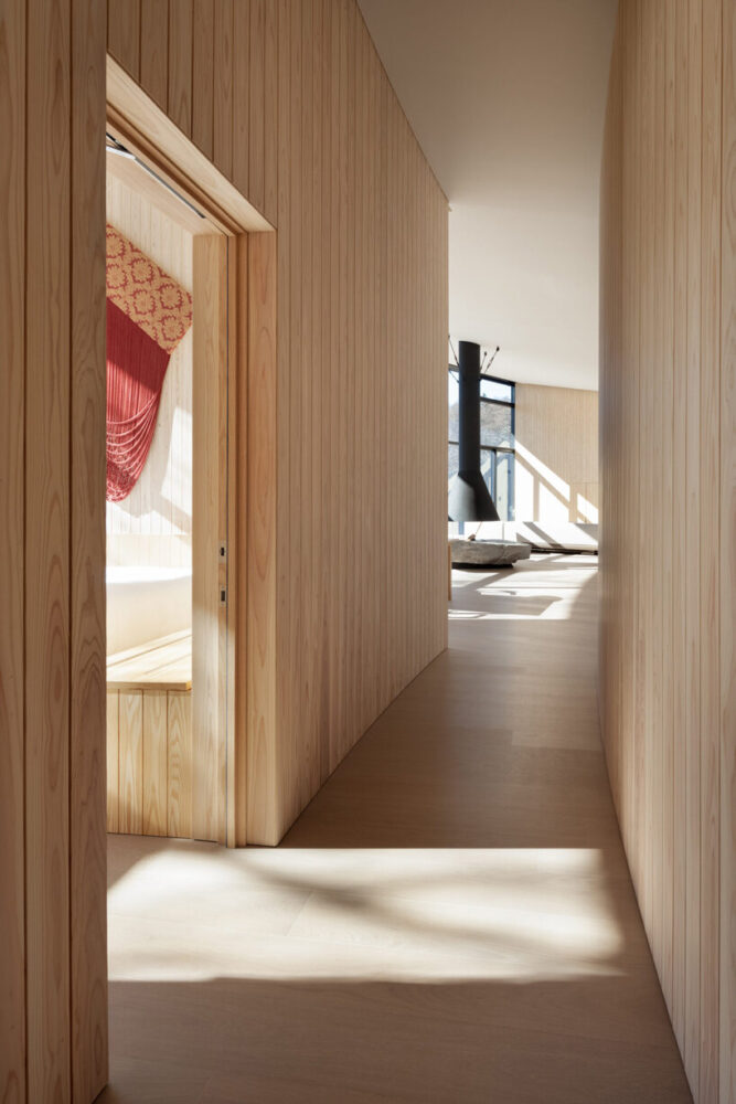 a curved central corridor arcs through the building like a hidden spine