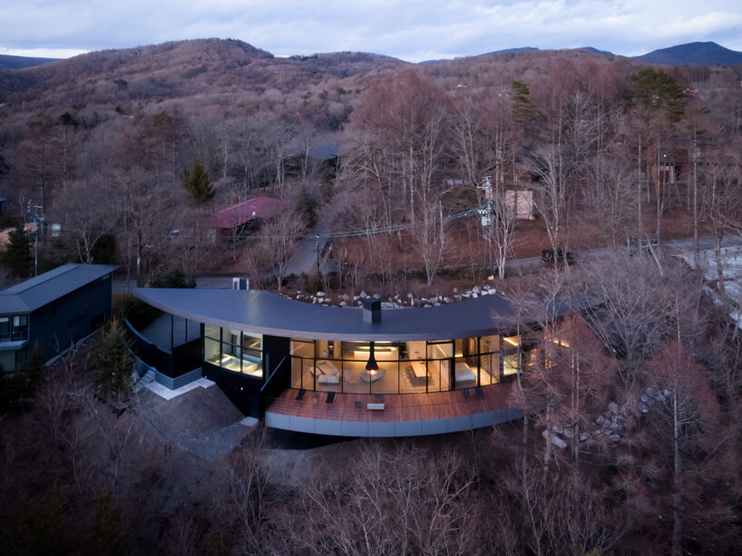 the inverted-conical roof that blends into its sloped terrain