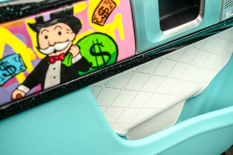 Alec Monopoly paints Mr. Monopoly around the model