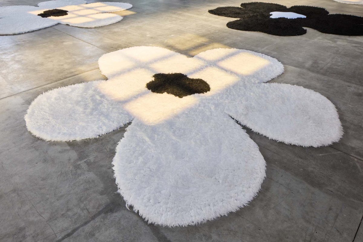 flower carpet islands by OMA bloom across prada's ss26 menswear showcase in milan