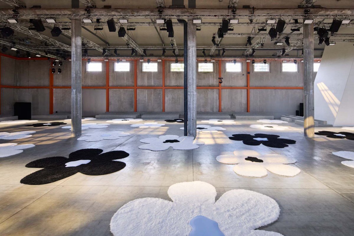 flower carpet islands by OMA bloom across prada's ss26 menswear showcase in milan
