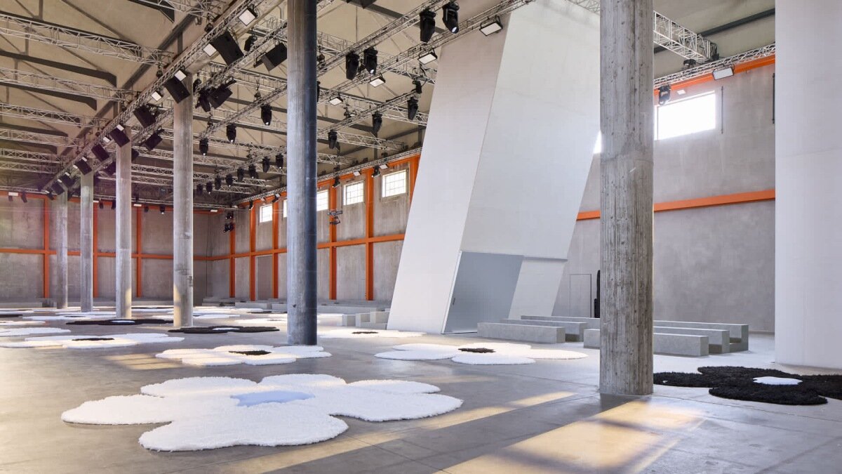 flower carpet islands by OMA bloom across prada's ss26 menswear showcase in milan