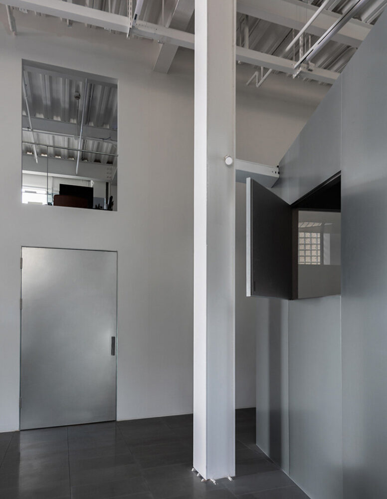 stainless steel surfaces add to the industrial character of the space | image by Atelier Siyu