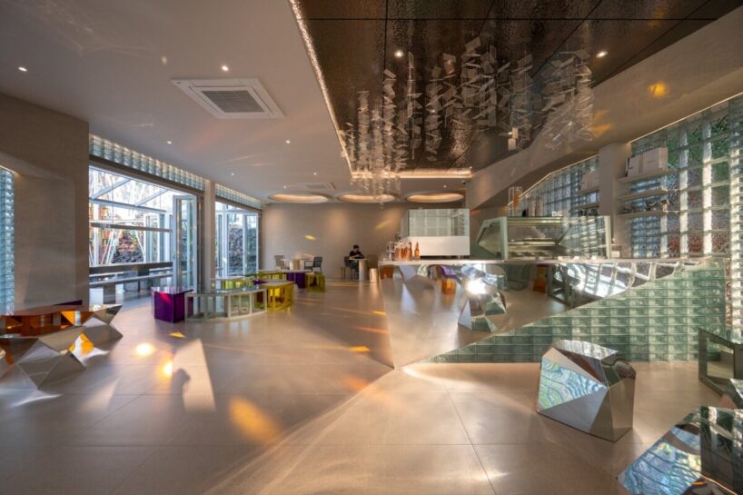 a sharply angular mirrored counter produces a refracted floor glow