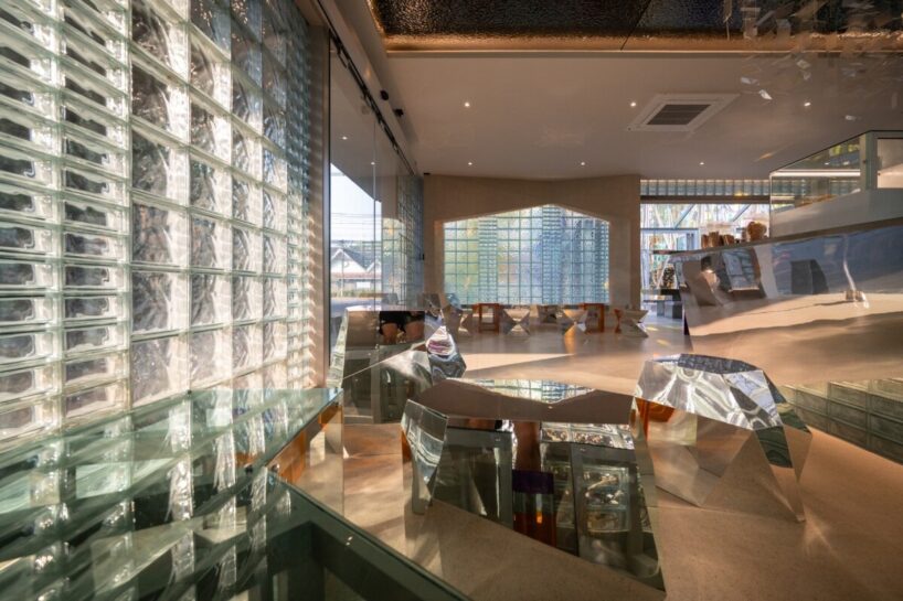 the chromatic restraint — white, silver, and translucent — allows the renovated volume to glow softly at night