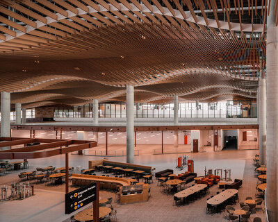 ZHA, COX & woods bagot shape sydney airport terminal with wavy timber-toned modules