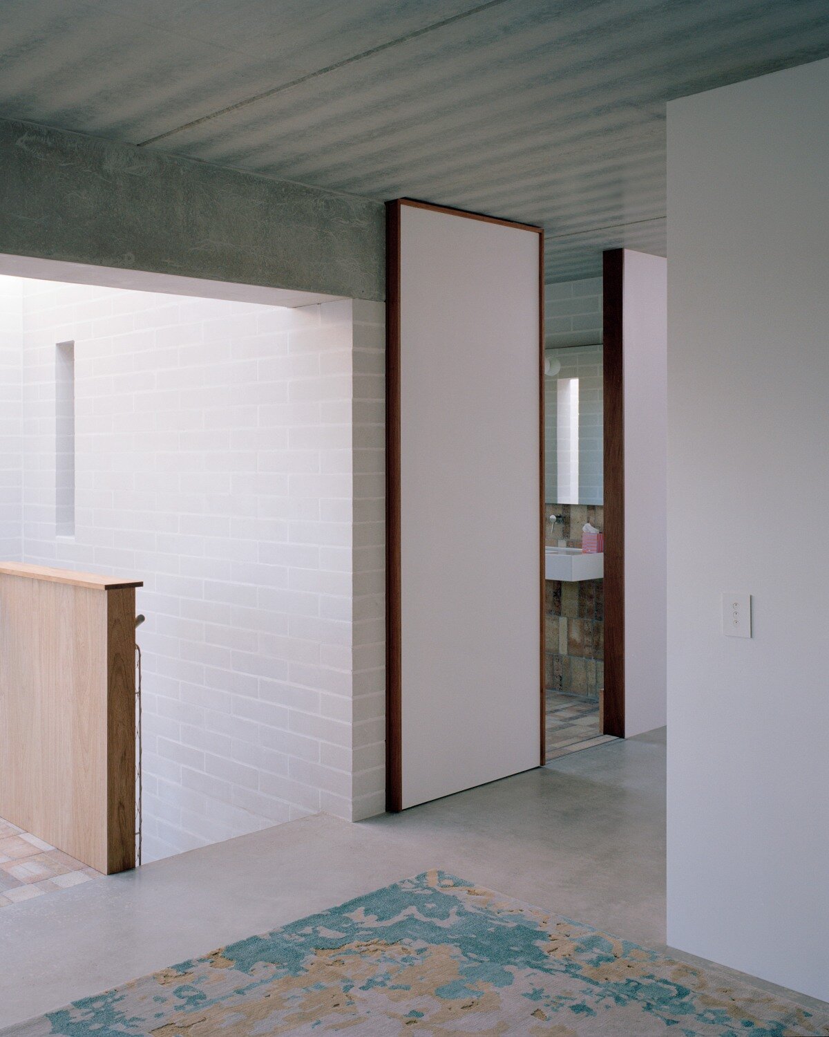 salvaged terracotta, bricks, and metal nets wrap around peter besley's australian house