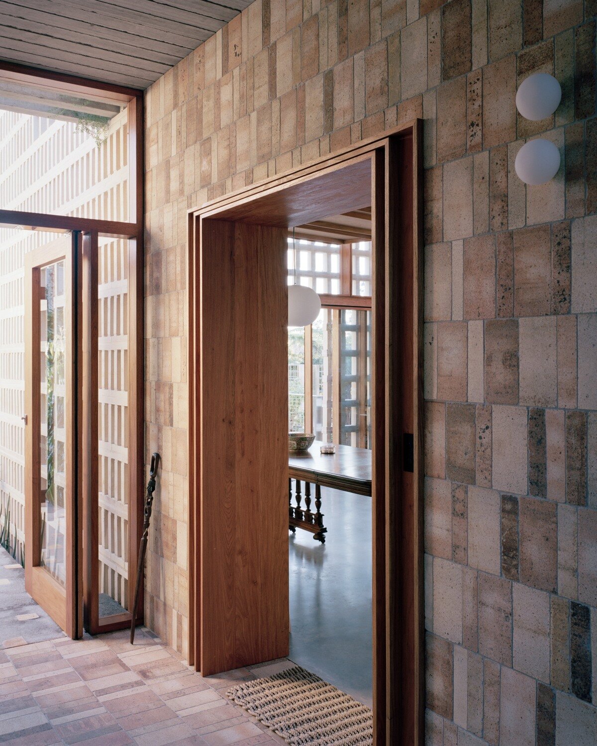 salvaged terracotta, bricks, and metal nets wrap around peter besley's australian house