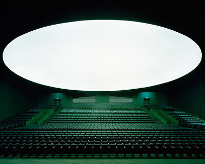 bofill taller carves elongated arches around deep green auditorium in morocco