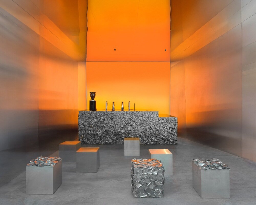 warm orange glow bathes crosby studios' chromatic café in paris 