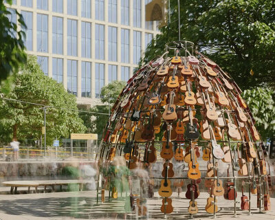 wind-powered sculpture turns donated guitars into sonic art installation in manchester