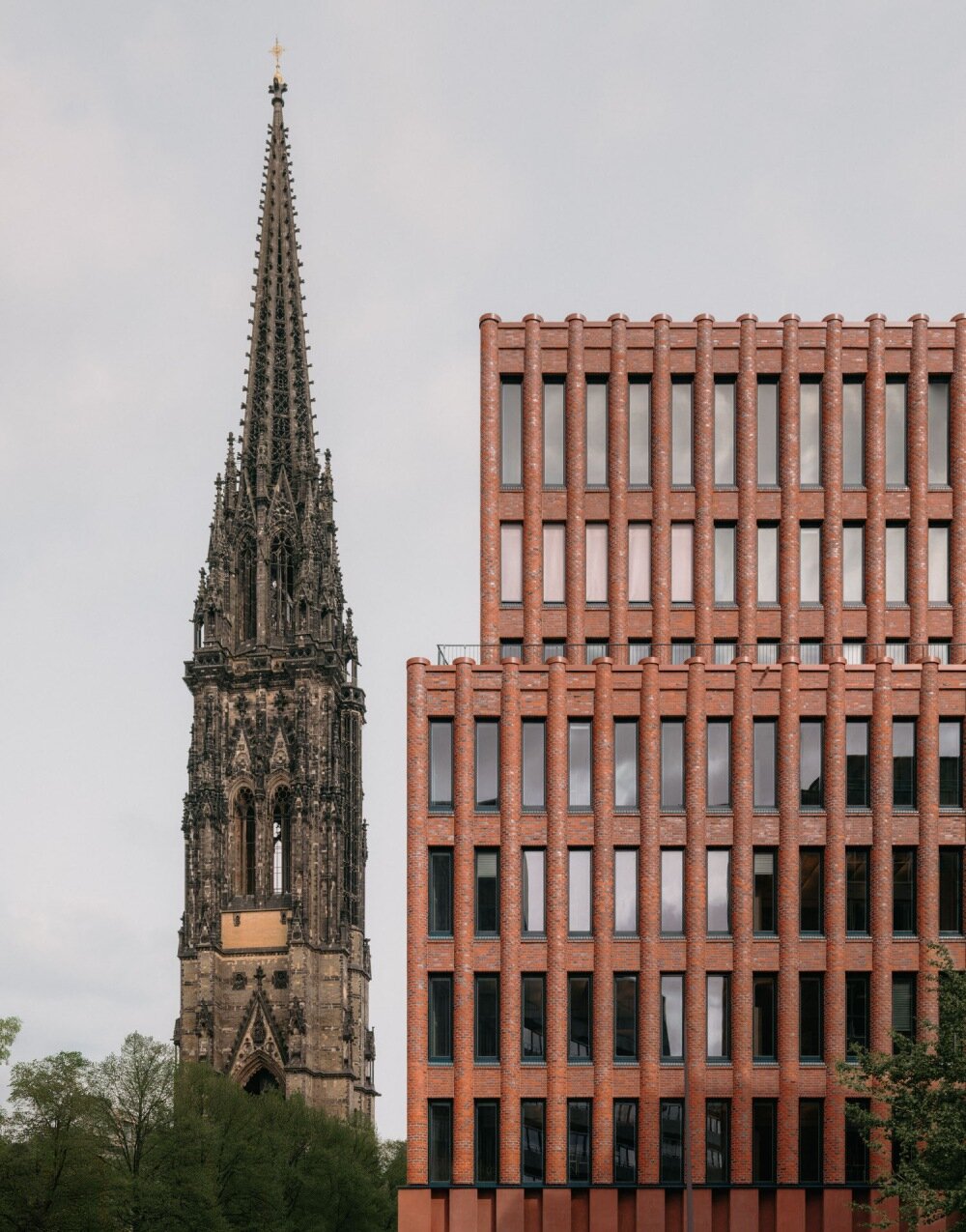 semi-circular red bricks clad christ & gantenbein's hamburg complex in rhythmic pattern