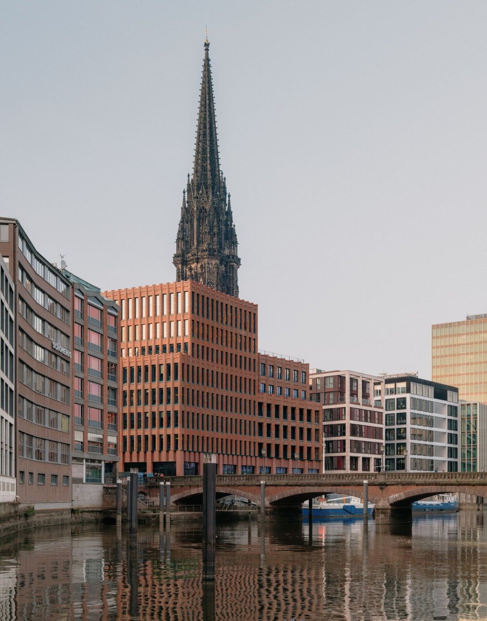 semi-circular red bricks clad christ & gantenbein's hamburg complex in rhythmic pattern