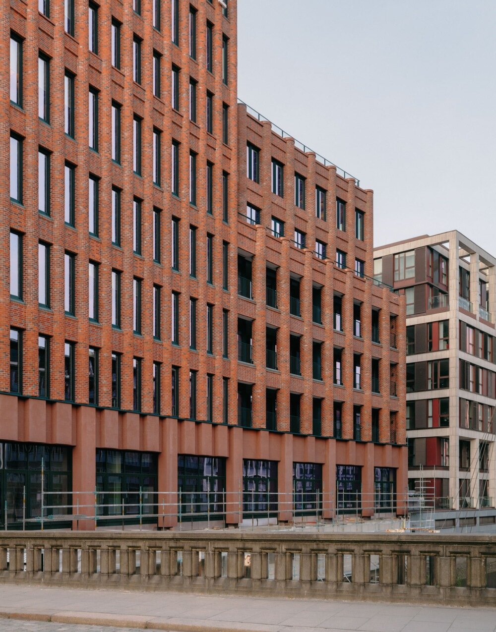 semi-circular red bricks clad christ & gantenbein's hamburg complex in rhythmic pattern