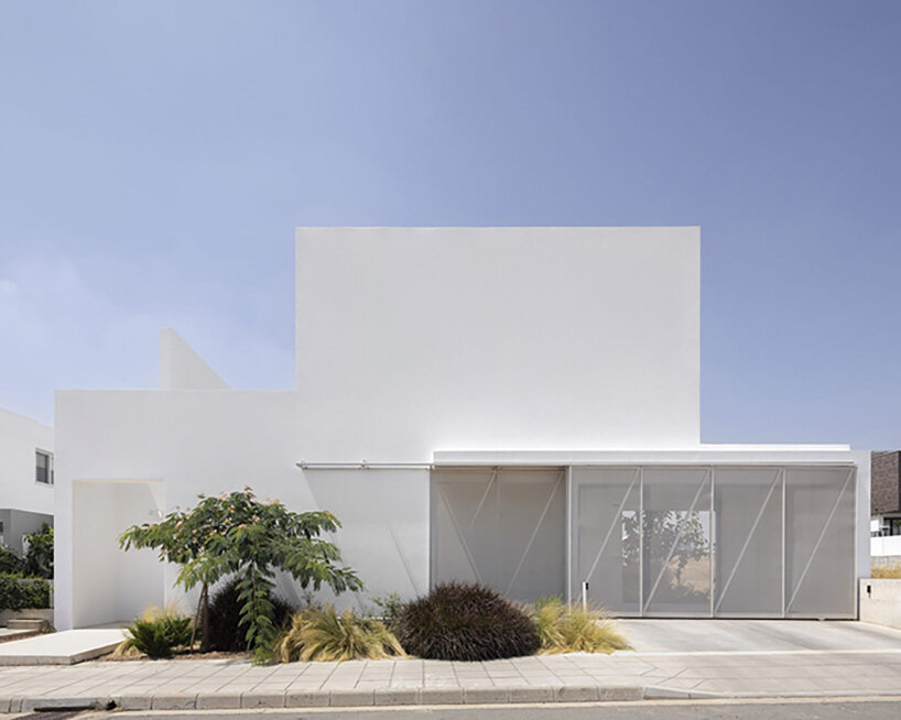 concentric white walls conceal garden-filled residence by draftworks* architects in cyprus